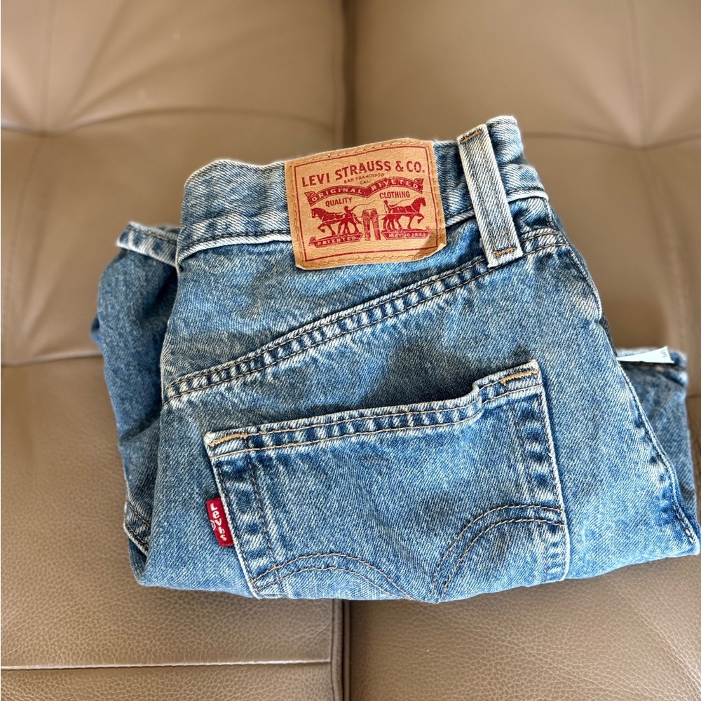 Size 28 Levi high-waisted blue denim shorts w/ no rips or fraying.